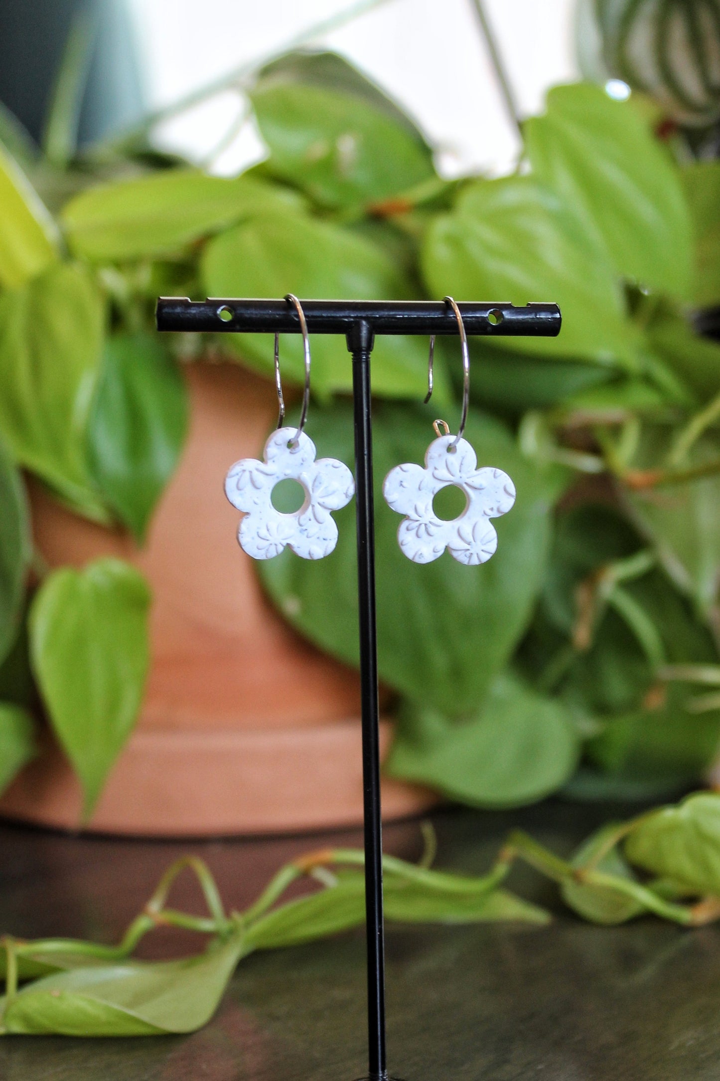 Daisy Print Hoops on white speckled clay with stainless steel silver and gold hoops 1.5 inch drop