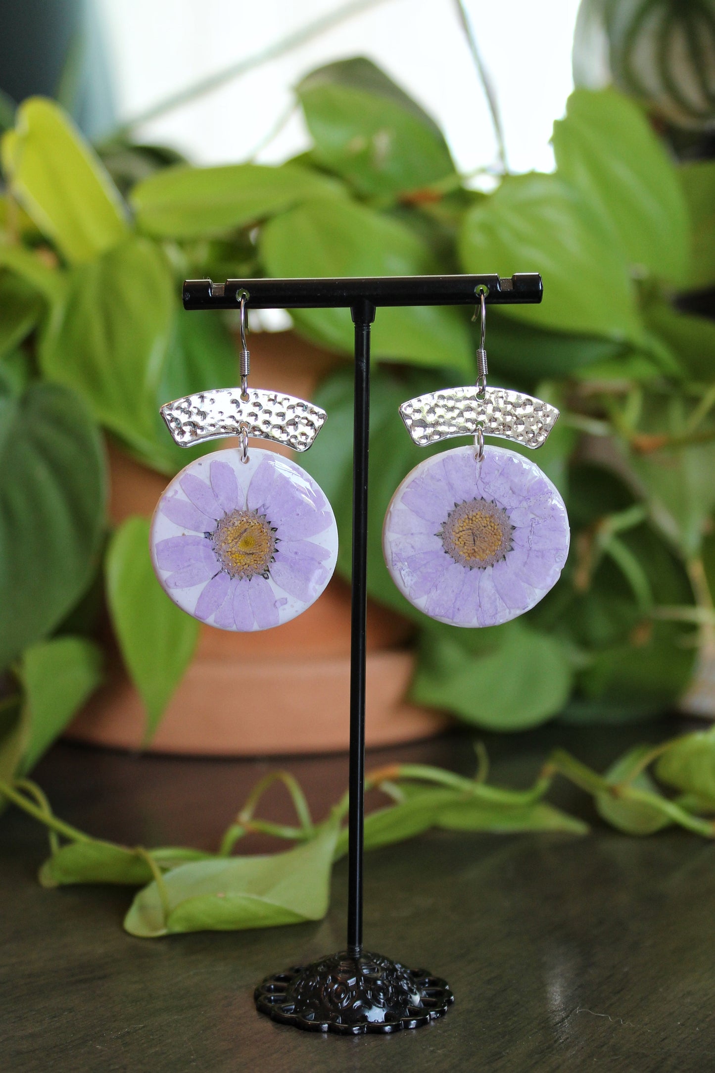 Purple daisies hanging on silver stainless steel ear wires with 2.5 inch drop