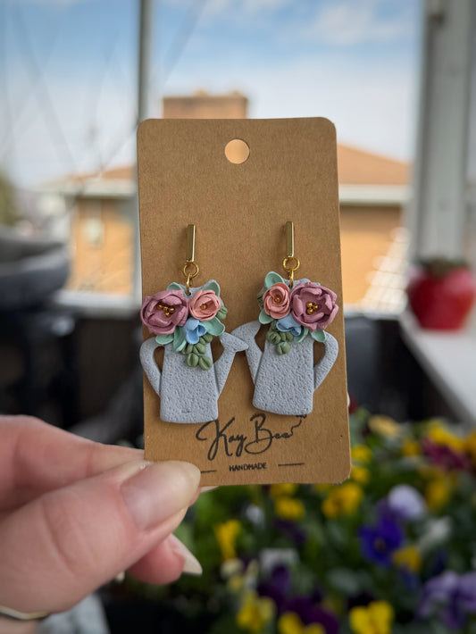 Floral watering can earrings with hand-sculpted flowers in silver and gold, lightweight and comfortable