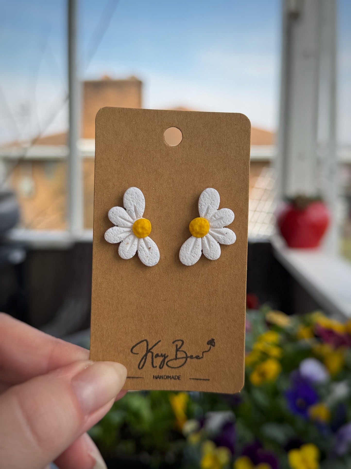 Half daisy stud earrings with one inch drop spring design
