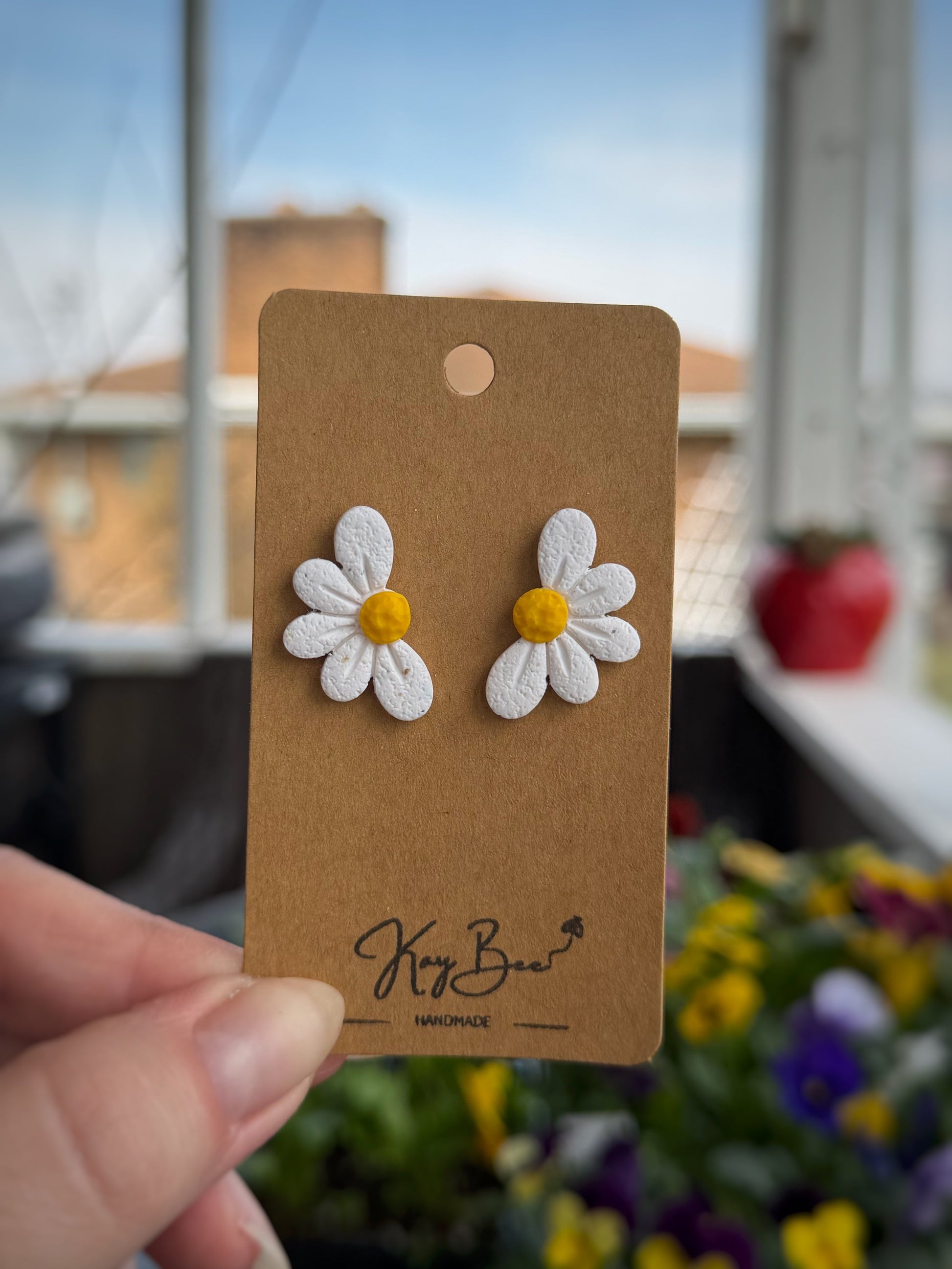 Half daisy stud earrings with one inch drop spring design